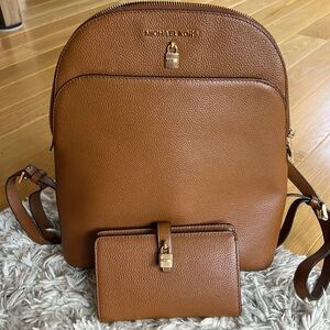 Michael Kors domed leather backpack bag with matching wallet.